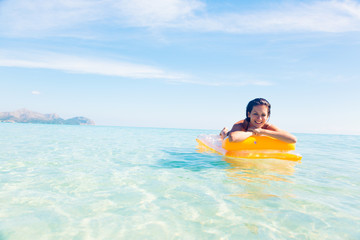 Fototapeta na wymiar Young Woman With Pool Raft