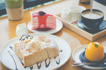 Honey toast with strawberry cake and hot coffee in cozy outdoor cafe