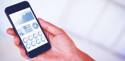 Composite image of womans hand holding black smartphone