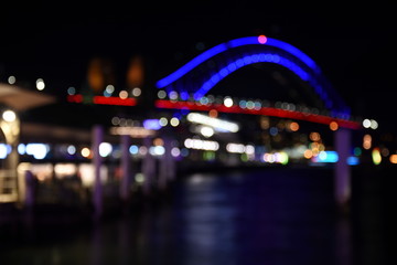 Bokeh with yellow, blue and purple colors, Night city lights background. Blurred Bokeh light vintage background, Abstract colorful defocused dot, Soft focus. Bokeh Sydney Harbour Bridge.