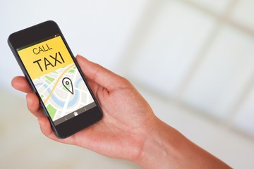 Composite image of womans hand holding black smartphone