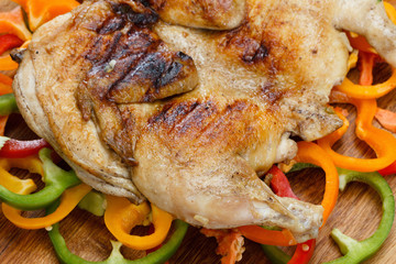 Fried food grilled chicken on a colorful background of vegetables