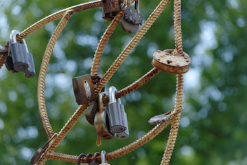 Many marriage love symbol padlocks chained on bridge