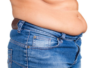 Naklejka premium Overweight woman getting dressed wearing jeans