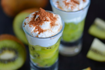 Dessert of kiwi and cream with cocoa