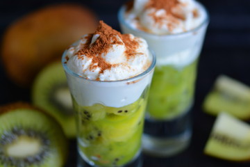 Dessert of kiwi and cream with cocoa