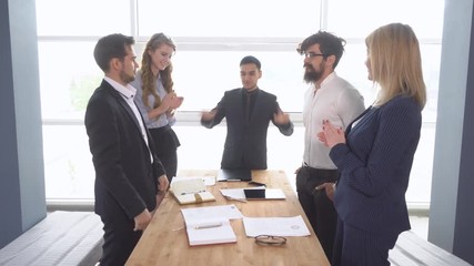Handshake of businessman at the conclusion of the transaction. business meeting. Successful negotiations of a group of young businessman in the office of the company