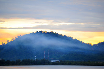 Fototapeta na wymiar Beautiful sunrise over sea with fog on mountain
