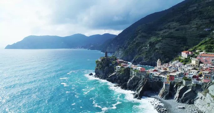 aerial view of travel landmark destination Vernazza, a small mediterranean sea town, Cinque terre National Park, Liguria, Italy. Afternoon sunny and cloud weather. 4k aerial drone forward video shot