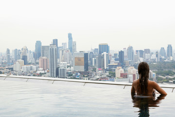 Woman relaxing on a rooftop pool