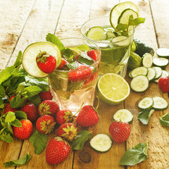Refreshing drink with strawberry, lime and cucumber