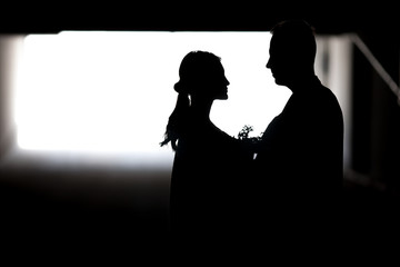 Silhouette of a couple in love. Black and white photo.