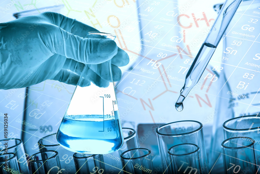 Wall mural flask in scientist hand with test tubes background
