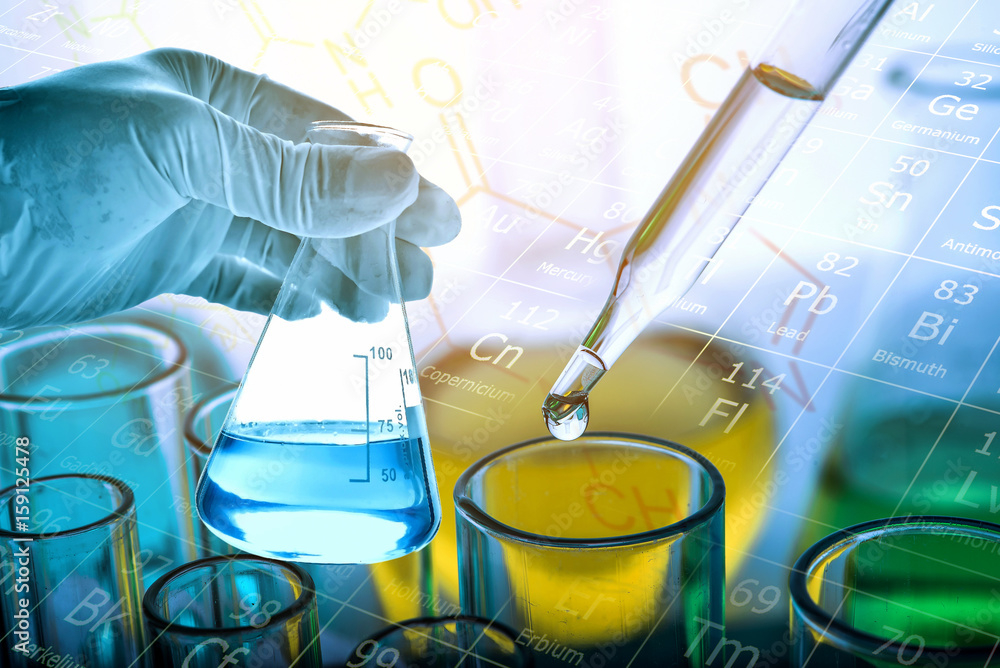 Wall mural flask in scientist hand with test tubes background