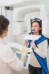 Dentist taking a panoramic digital X-ray of a patient s teeth