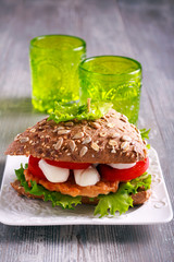 Salmon, mozzarella and tomato brown sandwich