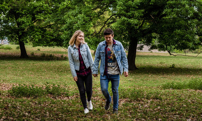 Fototapeta premium Young couple walking in the park