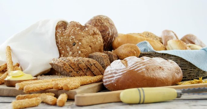 Various bread loaves on wooden table