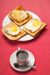cup of coffee and toast, egg on a saucer on a red table