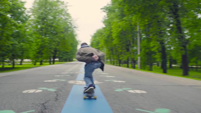 Young man riding on longboard