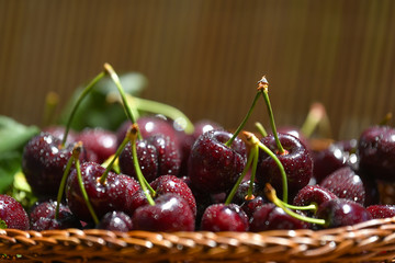 Fresh and ripe cherry berries in a wooden wicker basket