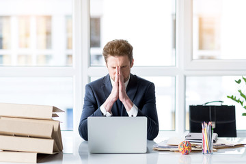 Frustrated young employee is working wearily