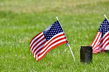 USA flag next to war veterans headstone
