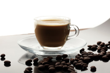 Coffee cup and coffee beans on table
