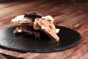 Melting chocolate and diffrent bars - stack and chips with chocolate swirl/ powder and cocoa pod with melted chocolate