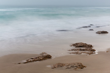 Seashore, sandy beach, blurred waves