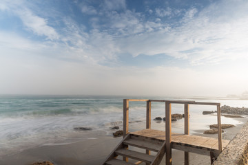 Fototapeta na wymiar Seashore, sandy beach, blurred waves