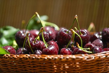 Fresh and ripe cherry berries in a wooden wicker basket