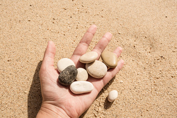 Pebble in the woman hands. Turkey, Kas, Kaputas beach.