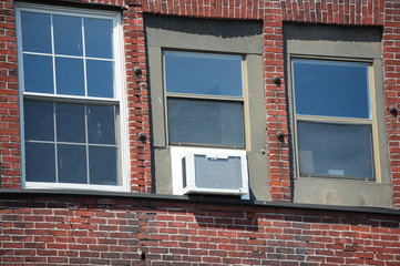 old air conditioner installed on house window