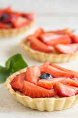 Mini tartlets with fresh strawberries and custard