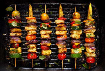 Grilled Vegetarian skewers with halloumi cheese and mixed vegetables on grill plate, top view