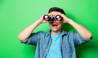 Young smiling man with binocular