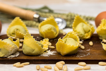 close up of homemade ravioli with flour and ingredients