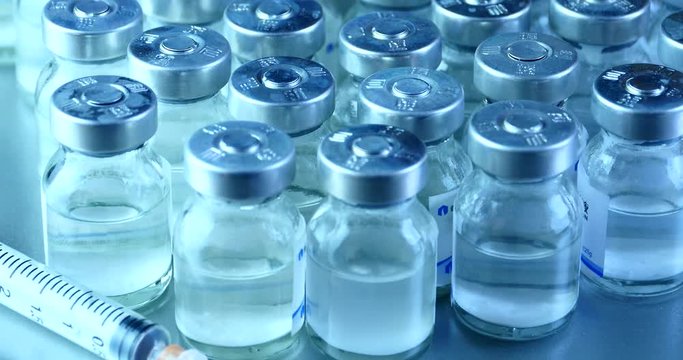 4k close-up of injection bottle&syringe injector.medical health hospital equipment & drug vial.