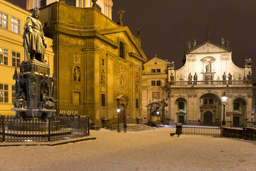 Bronze statue of the eleventh Czech King and Roman Emperor Charles IV. in night snowy Prague with Prague Castle near Charles Bridge, Czech Republic