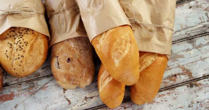 Various types of breads wrapped in paper bag
