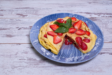 Pancakes with strawberries and mint pie with strawberries