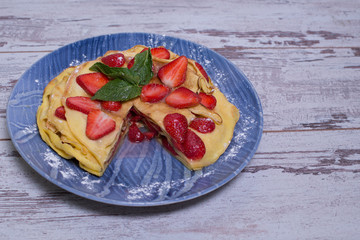 Pancakes with strawberries and mint pie with strawberries