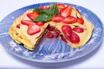 Pancakes with strawberries and mint pie with strawberries