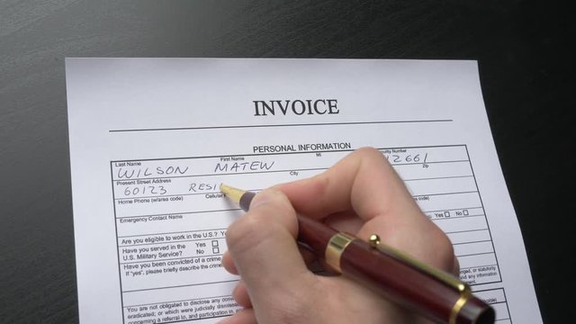 A person filling a invoice form. Closeup shot.