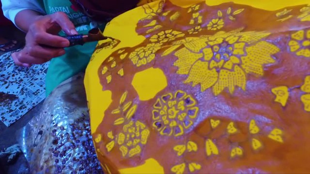 Painting batik on a fabric in Indonesia