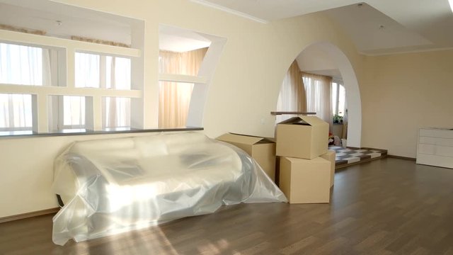 Boxes in the room. Modern flat interior. Low price apartments for rent.