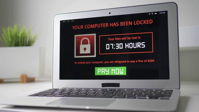 Laptop computer being infected by a ransomware virus that is asking for money to retrieve the encrypted files.