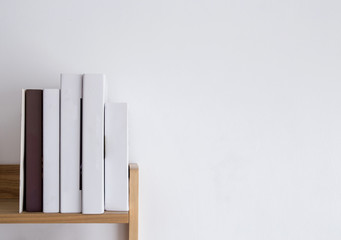 book shelf blank spines, empty binding stack on wood texture background, education concept