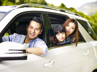 asian family traveling by car